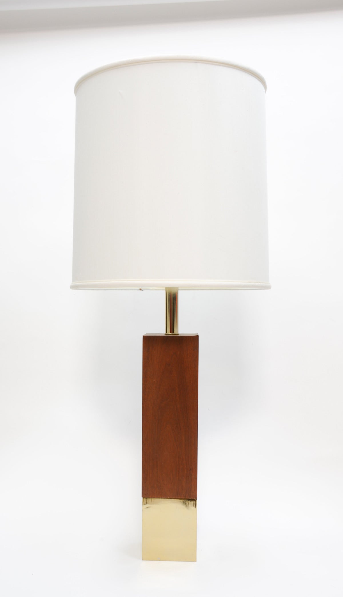These walnut and brass lamps are wonderful in the scaled. The bottom are a cast brass base. The tops are veneer walnut.