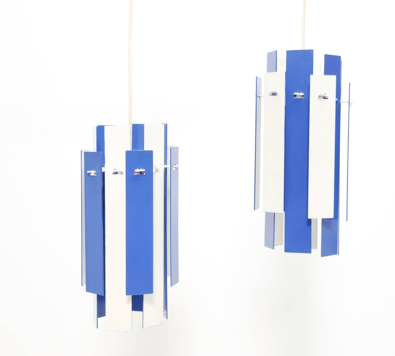 A wonderful pair of interchangeable hanging pendants from Denmark. The hanging bars can be flipped to change the colors from blue to white on both the inside and outside rings. Comes with 6