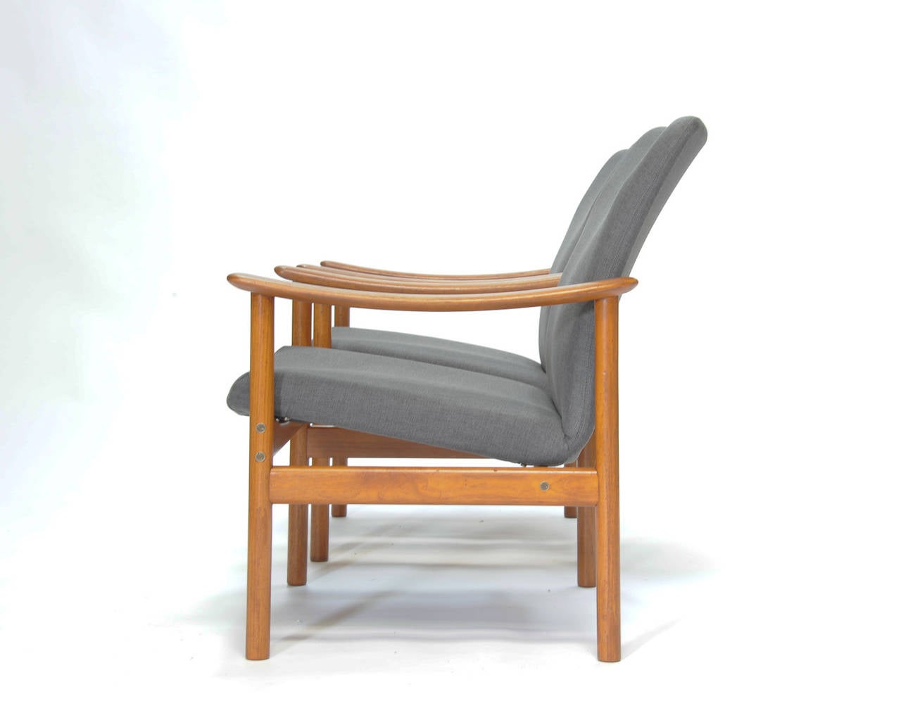 There is two pair of these chairs averrable for purchase. The teak and seat have been completely redone in a neutral gray wool. Dimensions: Arm height is 21.5