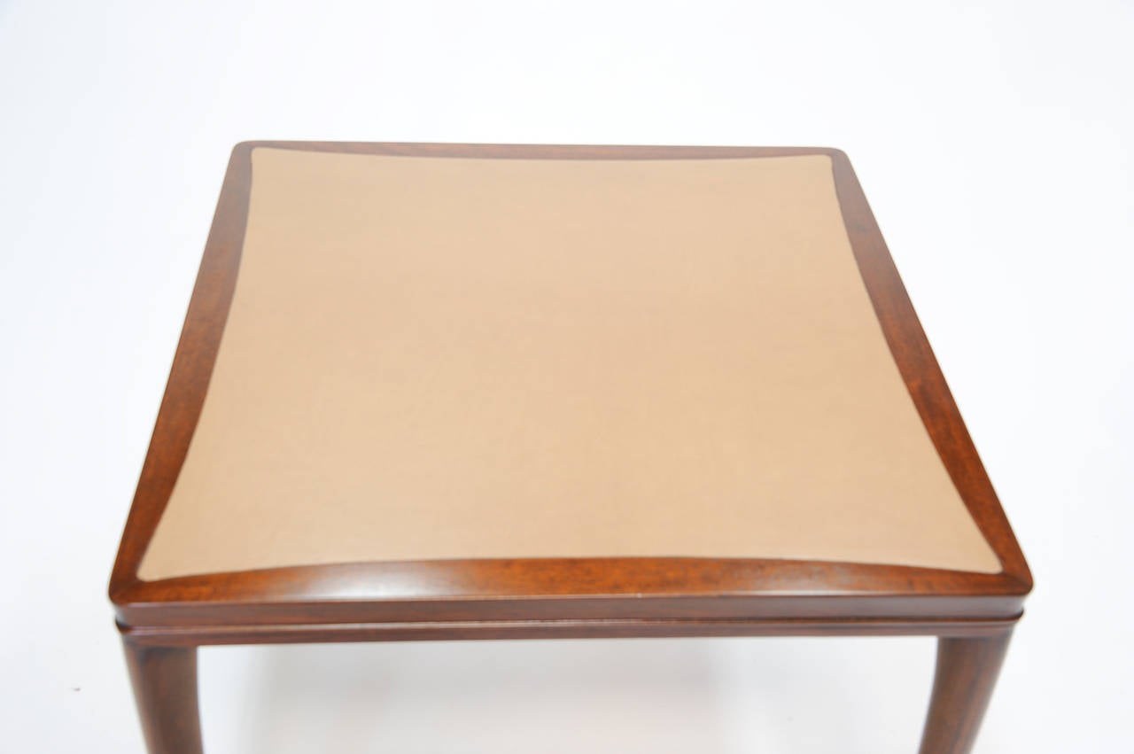 A wonderful and elegant card table by Wormley for Dunbar. The table has a leather inset to the top and sculpted curved femine legs. It retains it's early brown Dunbar bar label. The height under the apron is 25
