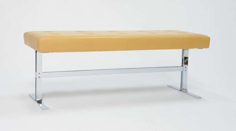 A elegant and simple bench by the Design Institute of America.  The top is covered in a light butterscotch Italian leather and the base in a solid chrome plated steel.