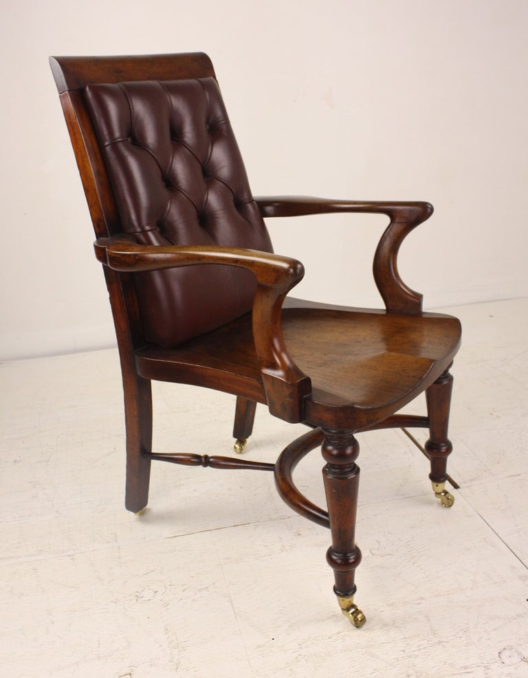 A PAIR of smart,classic English antique library desk chairs, beautifully shaped.   The mahogany has a lovely warm color and patina. The back has been newly reupholstered in rich burgundy leather. The reverse side of the back is also upholstered,