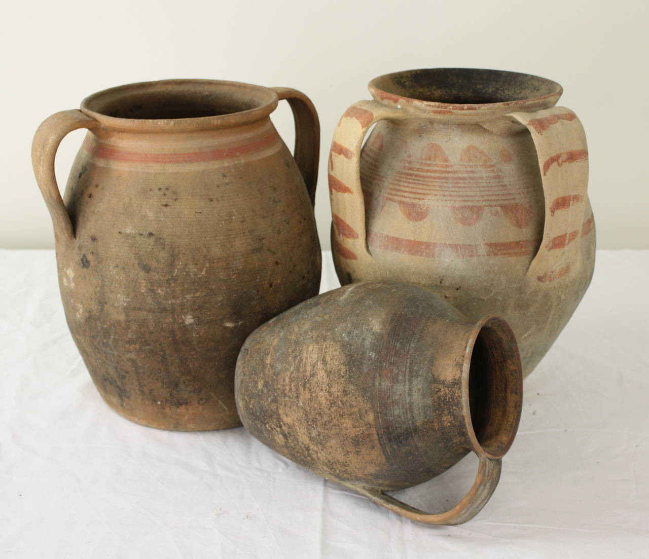 A most interesting group of pots, great dimensions and colors.  Hand thrown, blackened from the fire.  Measurements are for the largest jug.  The smallest measures 7