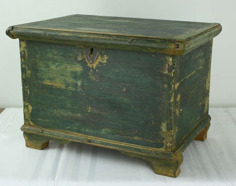 Delightful distressed storage trunk, in a smaller size. Beautiful old worn paint, hinges have had some work, one is new.  Little lidded tool box in the inside. Very nicely shaped feet.