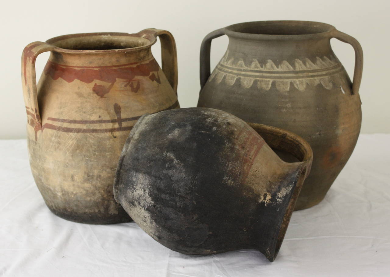 Collection of three large jugs. Great character and color, blackened from cooking in the fire. Measurement below is for the largest jug. Smallest measures 7