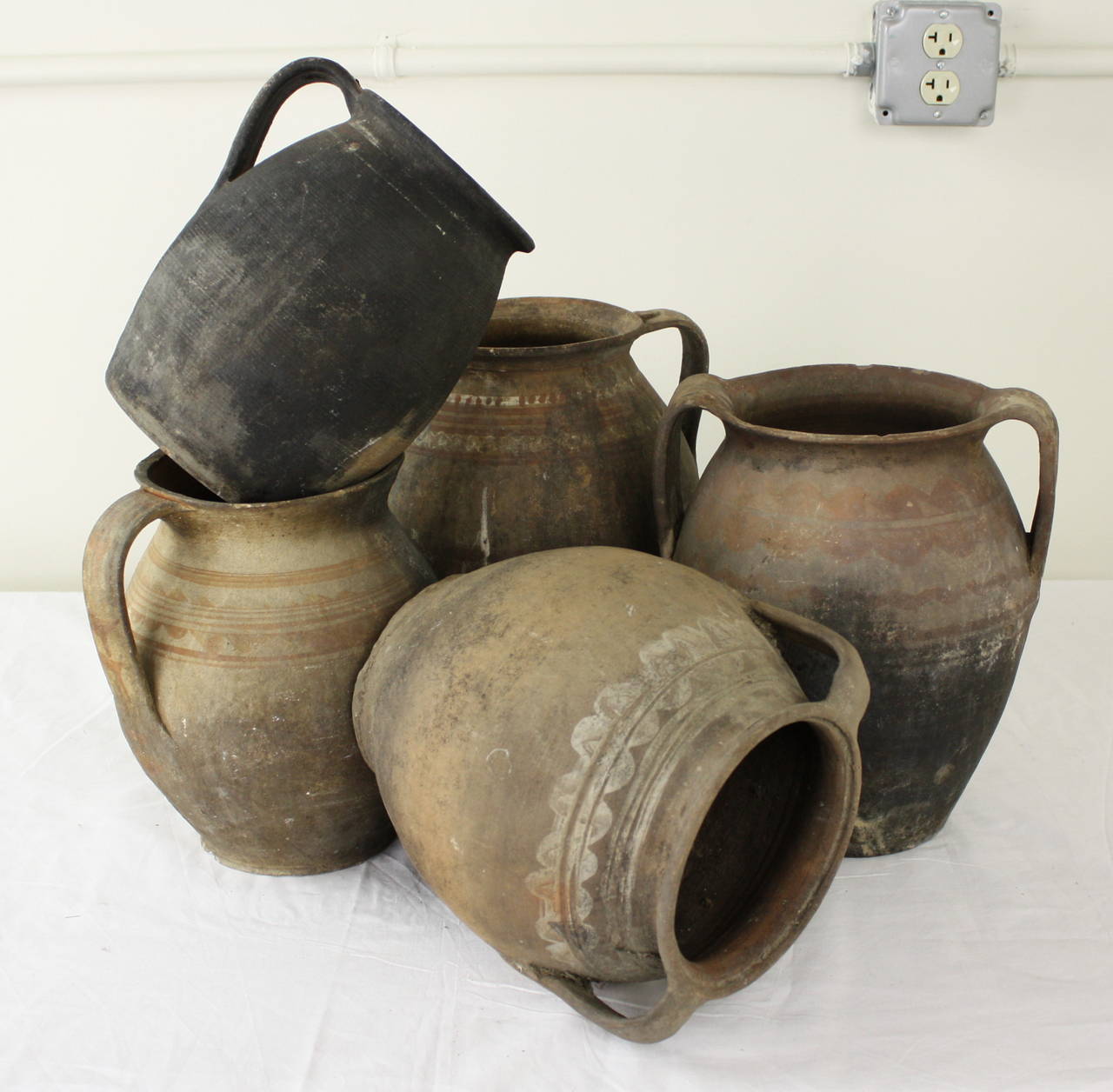 A very interesting rustic collection of jugs, great on top of a cabinet or armoire. Measurement below is for the largest jug. The smallest measures 7