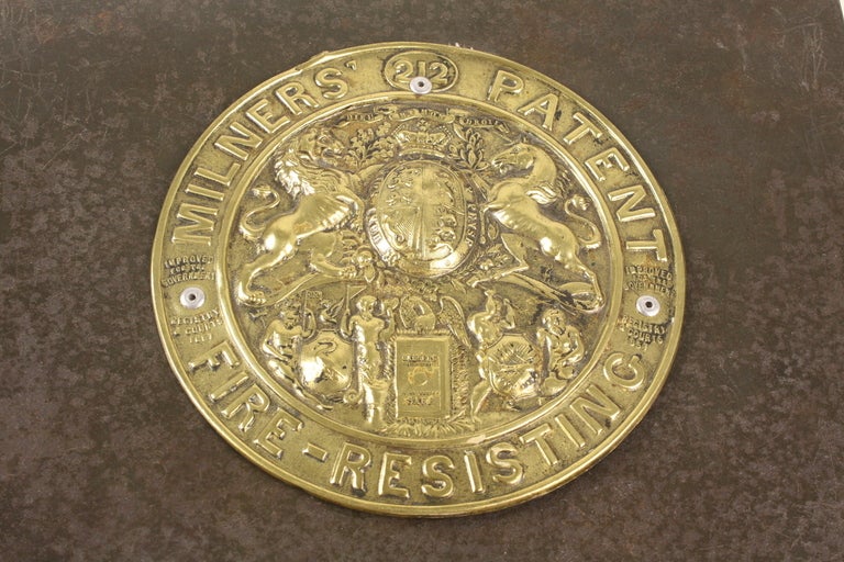 Steel box on a smart chunky new stand, with large decorative brass plaque on the top. A good end table or side table. Very decorative.