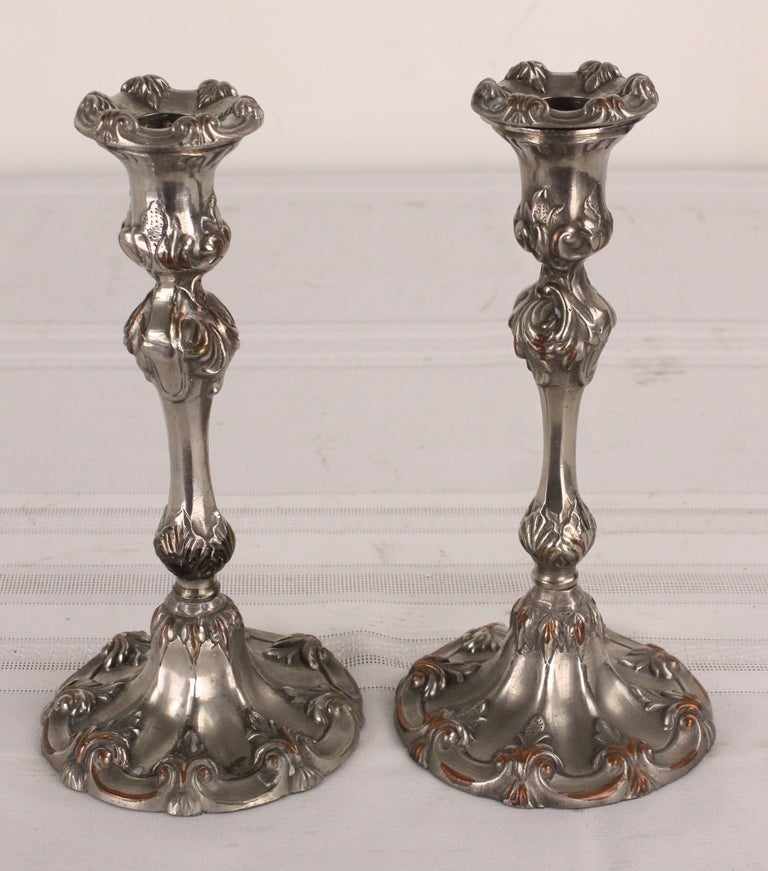 Decorative pair of pewter candlesticks, straight and sturdy. Quite attractive, with some copper show-through where candlesticks have been buffed. Very nicely engraved in classic Victorian patterns. Reduced NT