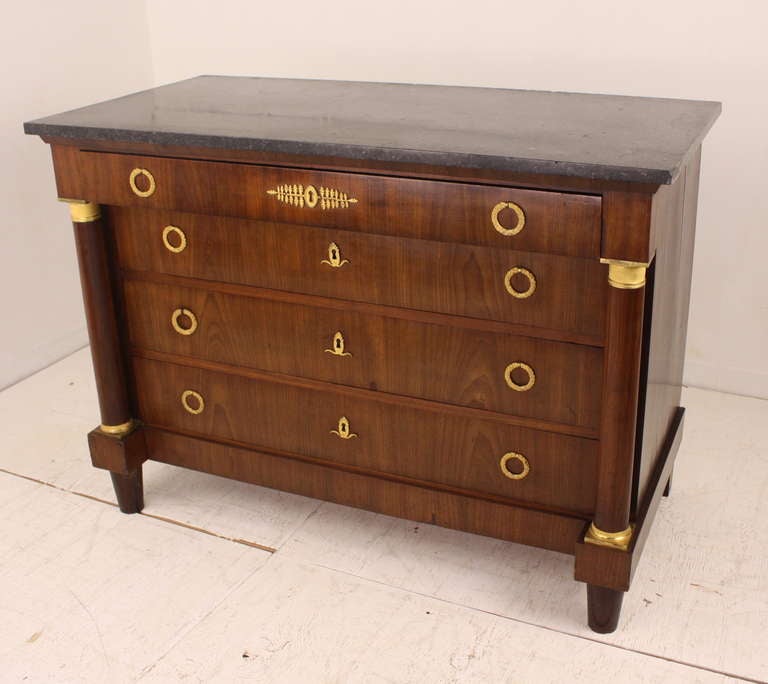 Stunning chest of drawers, with original marble top. Replaced bronzes in the original style. The vertical side columns with original bronze tops and bottoms are dramatic and elegant. Drawers slide easily, and the overall impression is just