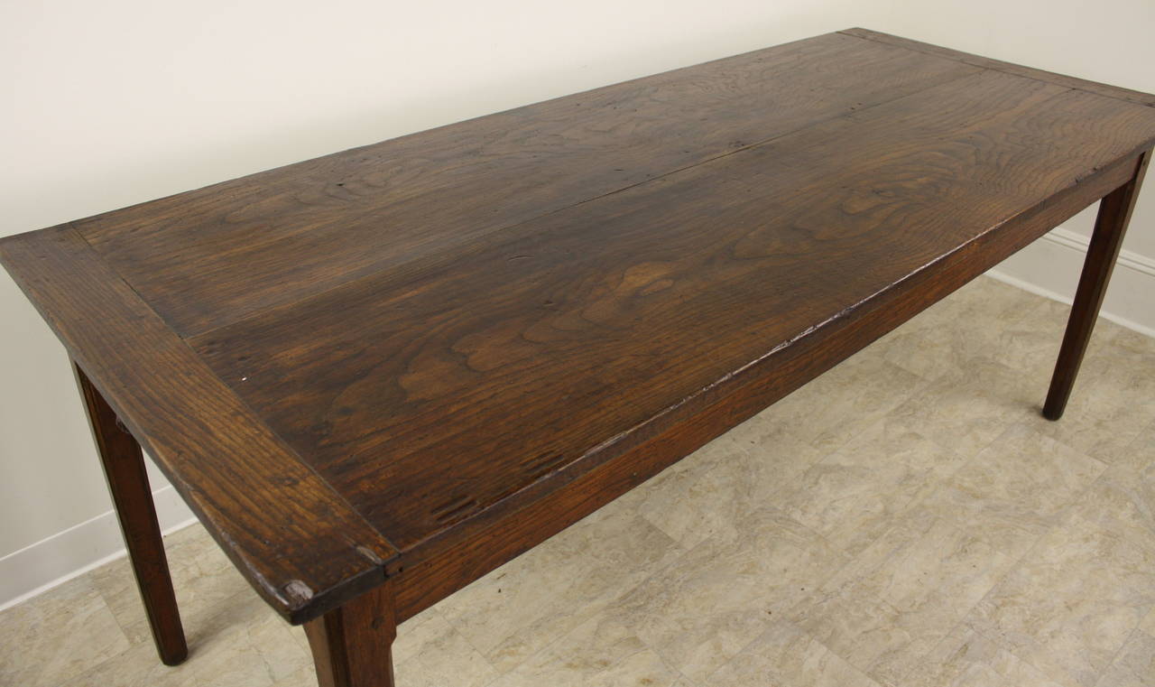The two-plank top is a fine indication of this table's age, when such wide planks were available to make these wonderful looking table tops.  The elm has a great color and patina, while the lovely grain is quite visible. Breadboard ends on the top