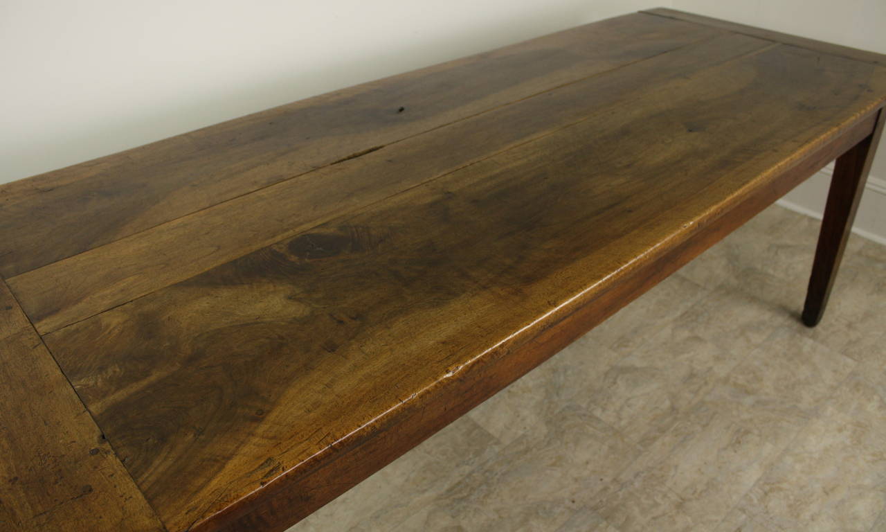 Most importantly, this table has the most beautiful walnut grain!  Terrific color and patina enhance the overall look.  There are breadboard ends. There is a charming little knothole on the top of the table.  The classic tapered legs are set at the