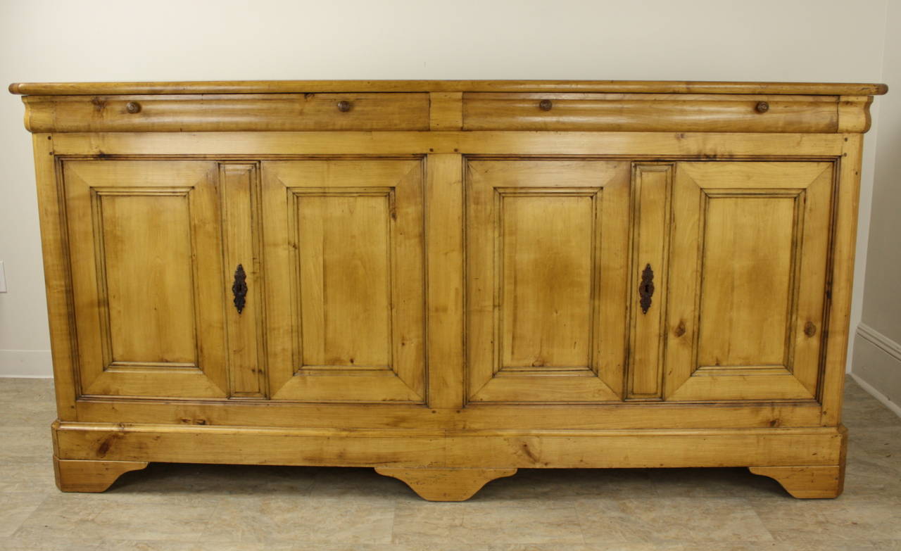 This stunning Louis Philippe enfilade offers all the Classic elements of a perfect Louis Philippe piece. Shaped drawers and feet, and because it is so long, it has four doors, for the two large cupboard spaces behind them. The Applewood used for