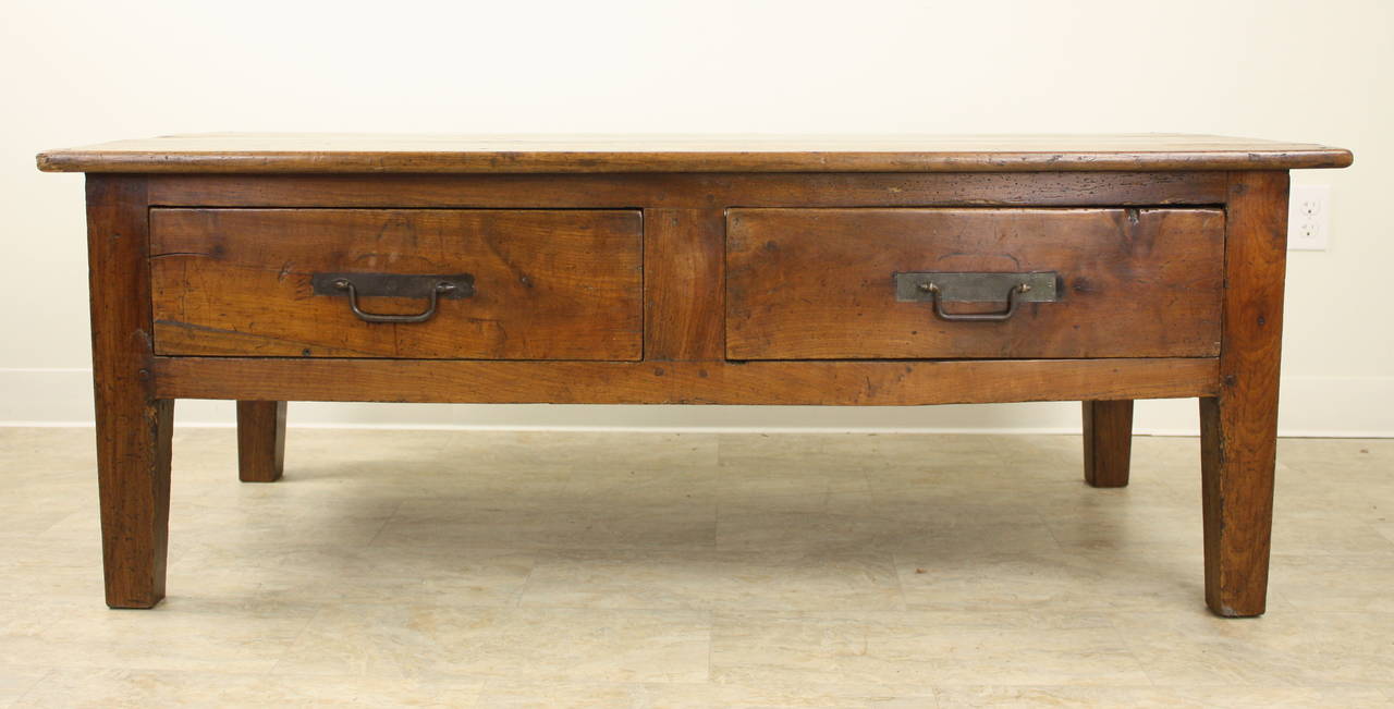 An impressive coffee table, lovely cherry with excellent color, patina and graining.  Paneled on three sides, with the front having two large drawers.  Note the third thumbnail shows the paneled back. Strong and sturdy, yet still elegant because of