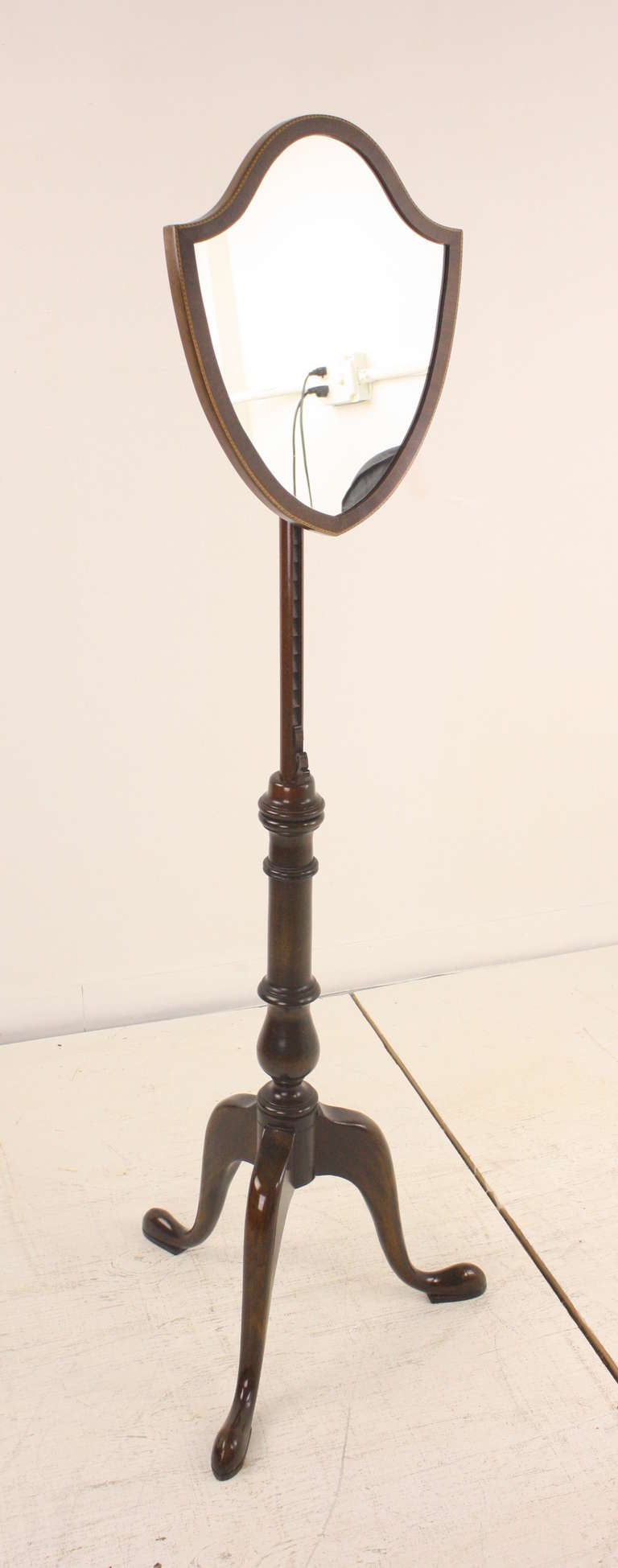 Elegant standing mirror, Classic Georgian shape. Lovely frame for the mirror adorned by excellent marquetry work. Graceful shaped feet. Adjustable. Height extends from 46