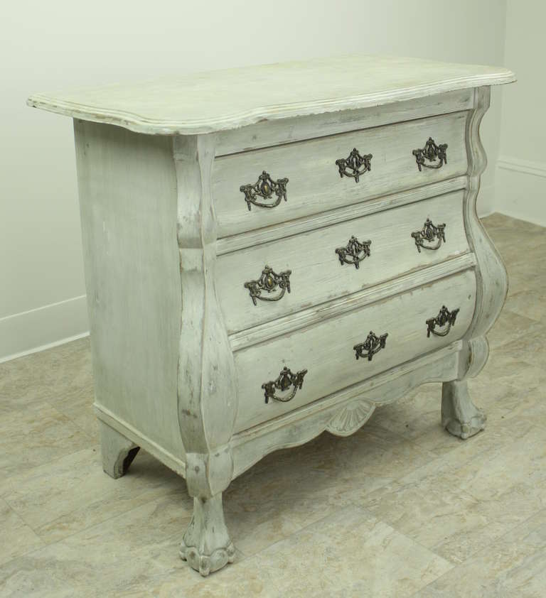 Very sweet, this smaller-sized chest would serve in lots of places, from a nightstand to an end table. This in a vintage copy (c 1920) of the period classic. It has lovely old handles, true to the period look, and also has well-carved feet. The very