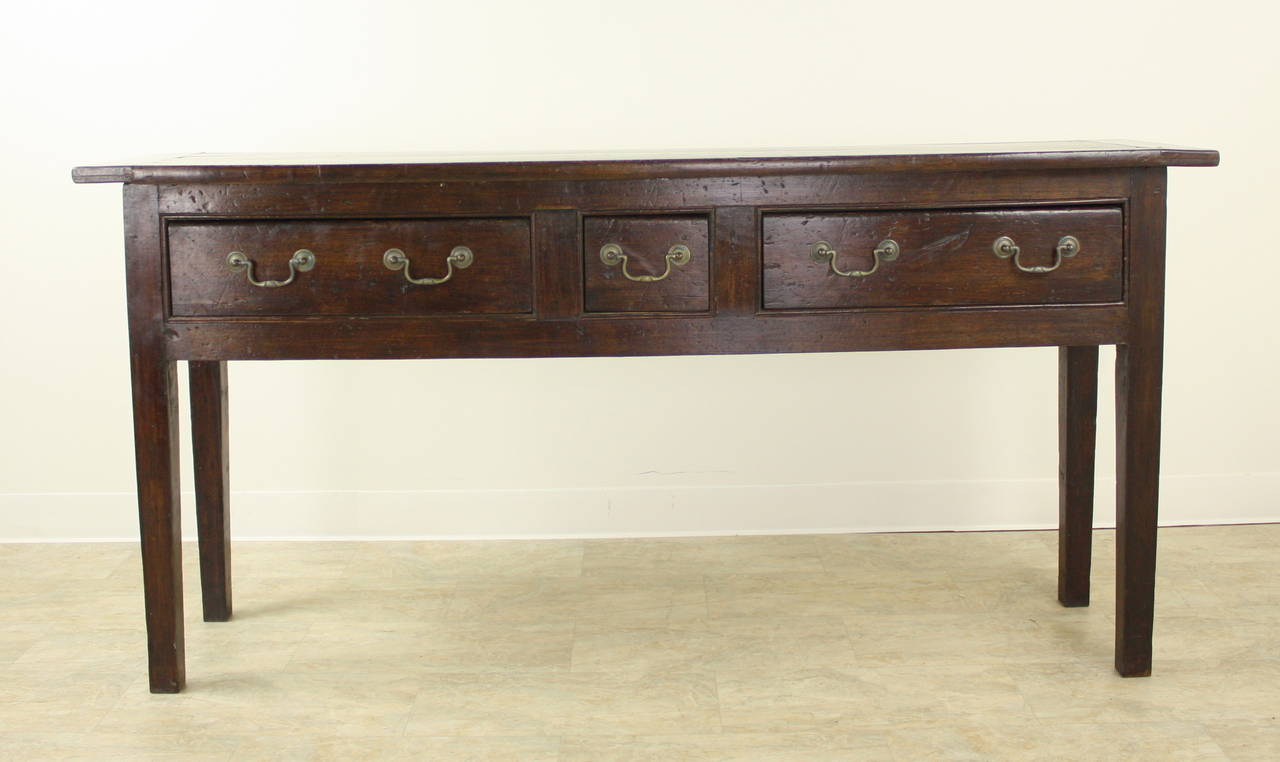 Very handsome elegant country sideboard.  The rich dark color is complimented by the breadboard ends on the top and the lovely carved edges on the drawers.  If used in the dining room the height will be above the dining table height, for a good