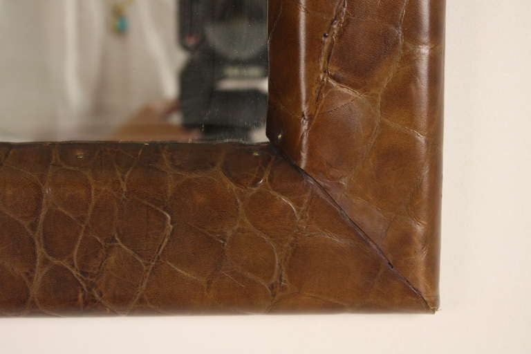 Leather has been embossed to simulate crocodile. Fun mirror for a smaller wall space. Handmade in England, 1980s.