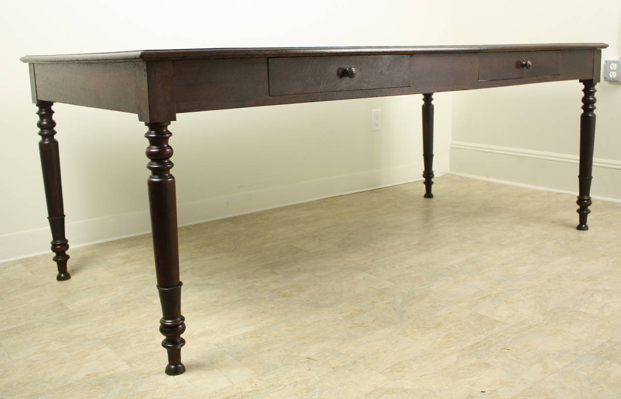 This table is somewhat more formal than many country farmhouse dining tables, with its slender beautifully turned legs.  The overall look is elegant, and the lovely wide top is set off with a band with  mitered corners and an ogee edge.There are two