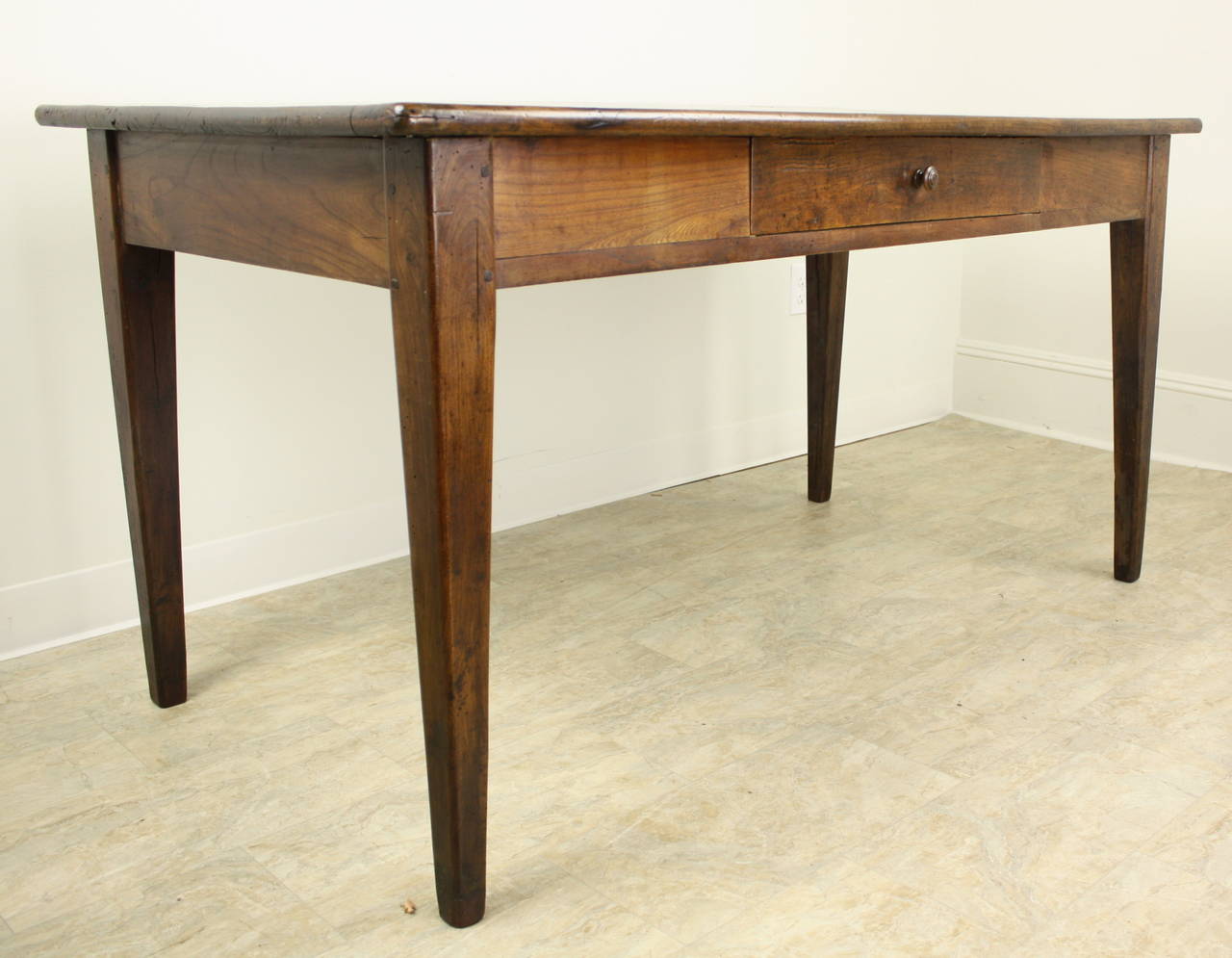 This desk is a very classic French style, with lovely slender tapered legs, and one drawer in the apron.  The cherry is a warm beautiful color, with a fine patina.  Legs are pegged in the traditional style.  Apron height is a good 24