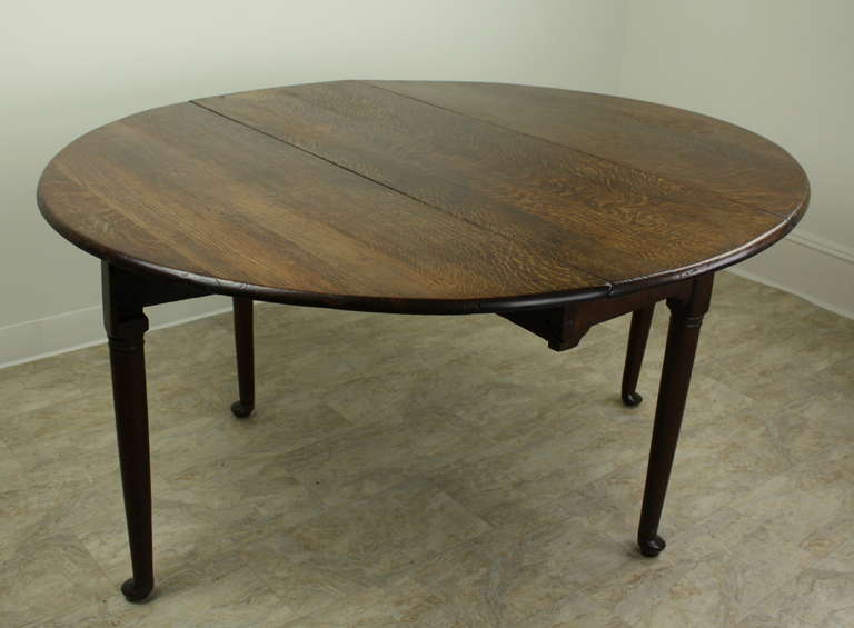 Elegant shapely dining table, Right in every way, with perfect Queen Anne pad feet. Lovely color and patina. Extremely useful,as a breakfast or lunch table.  While it is a bit low, there is a practical apron which allows room for knees.  The gate