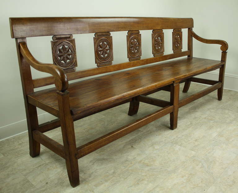 Gorgeous and elegant long bench, beautifully shaped arms, and unique carved back.  Good depth to the seat for comfortable sitting.  Very lovely color and patina.