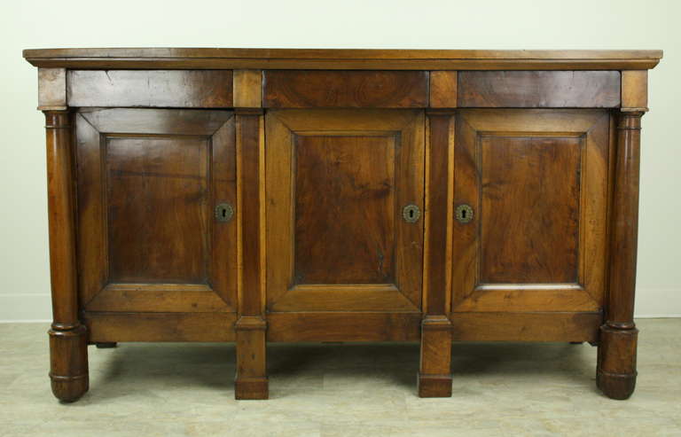 A very beautiful piece, elegant, with most desirable walnut color and lovely patina.  Lots of storage in this console, lovely panels on front and sides, great vertical columns and shaped feet.  Stunning credenza.