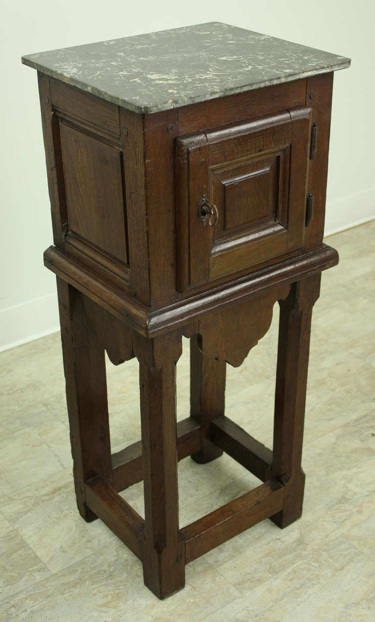 Charming little side table, or nightstand.  Very attractive, pretty marble top,  Nicely shaped apron, Good storage space for next to the bed.  Pretty fruitwood cupboard with good panels and good color.
