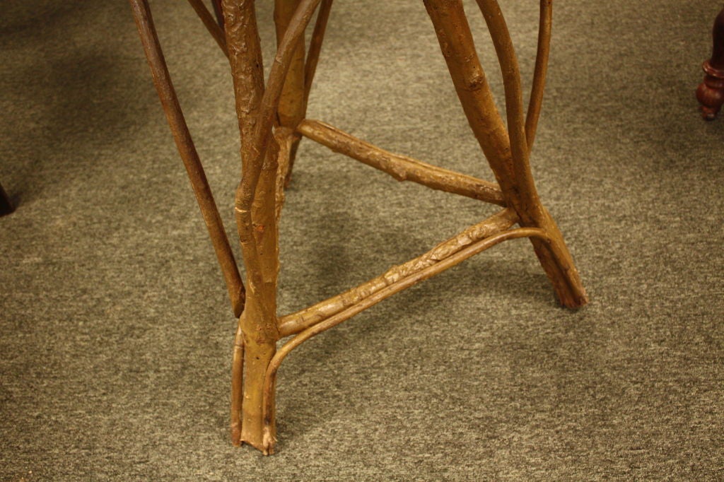 An antique twig table from Ardeche France. Very interesting pattern on the round top, and outstanding twiggy legs. Clearly handmade with great care, with a feeling of Tramp Art. Would make a terrific lamp or occasional table.