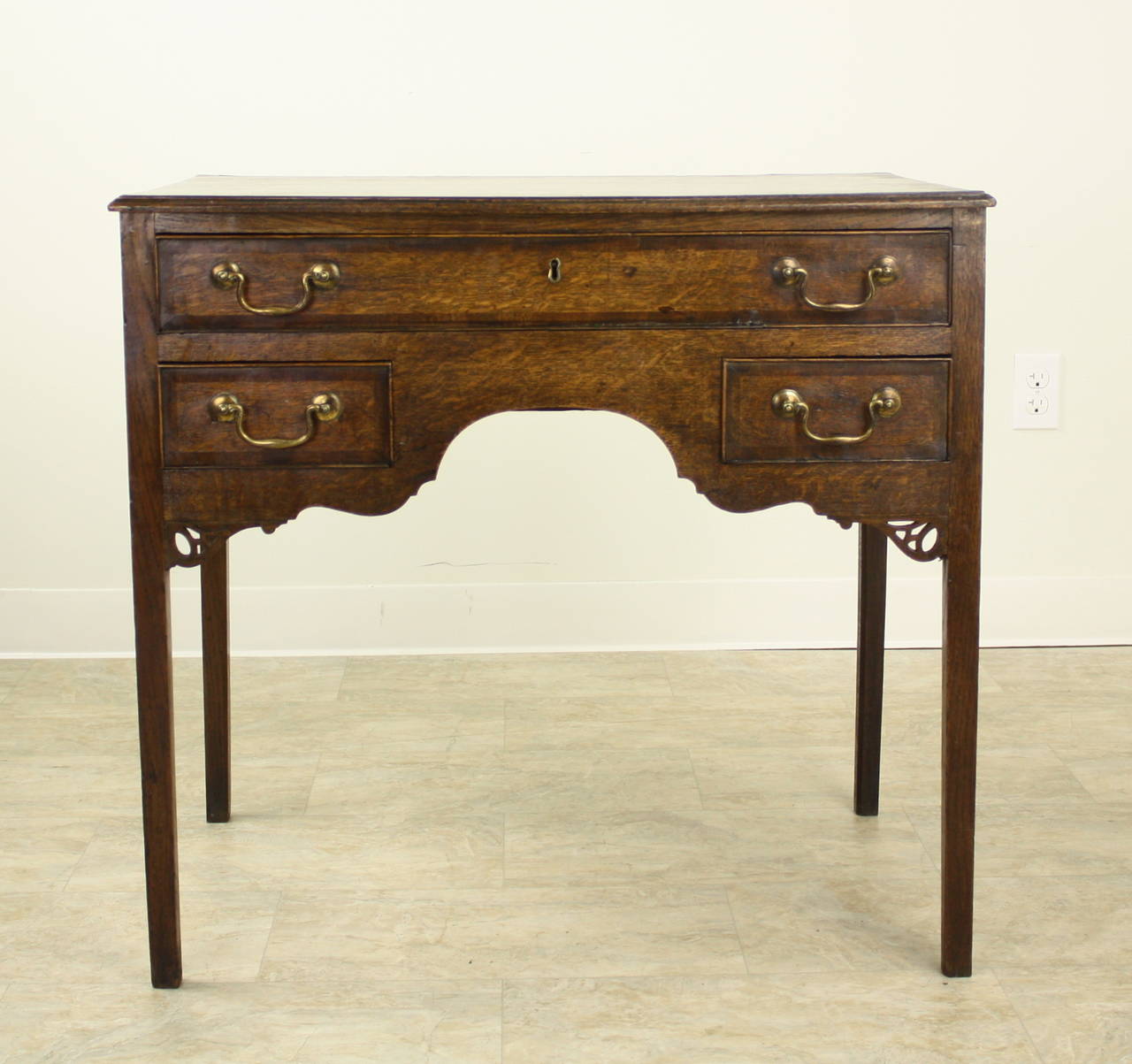 Beautiful example of a period Welsh oak lowboy, Simple classic lines, with a small hand-carved fretwork decorative element below the drawers on each side. Extremely well designed and well-made with mahogany crossbanding on the drawer fronts. Very