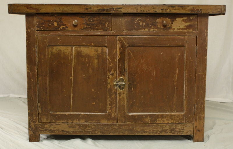 An antique painted sideboard from France. Made of beech wood with a butcher block top. The old paint gives this cupboard a great rustic look. Two drawers and a cabinet below with a shelf for good storage.<br />
<br />
See similar examples of