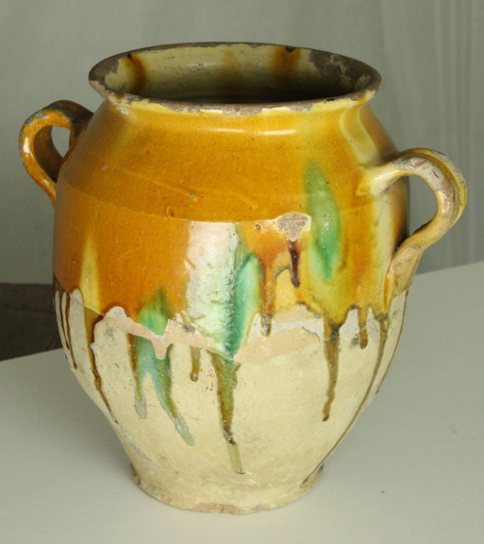 Examples of French yellow glazed earthenware confit pots, with deep honey yellow slip glaze, some with desirable green drips as seen on the largest piece.  Some have bold glaze drips on the exterior with the typical flakes and crazing that are