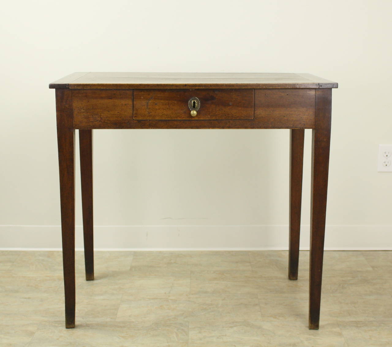 A lovely smaller end  table, or lamp table, in a beautifully grained walnut, very attractive patina.  The right height for a small desk, one small drawer in the apron, and a good height for knees.  A pretty brass knob on the drawer. Would make a