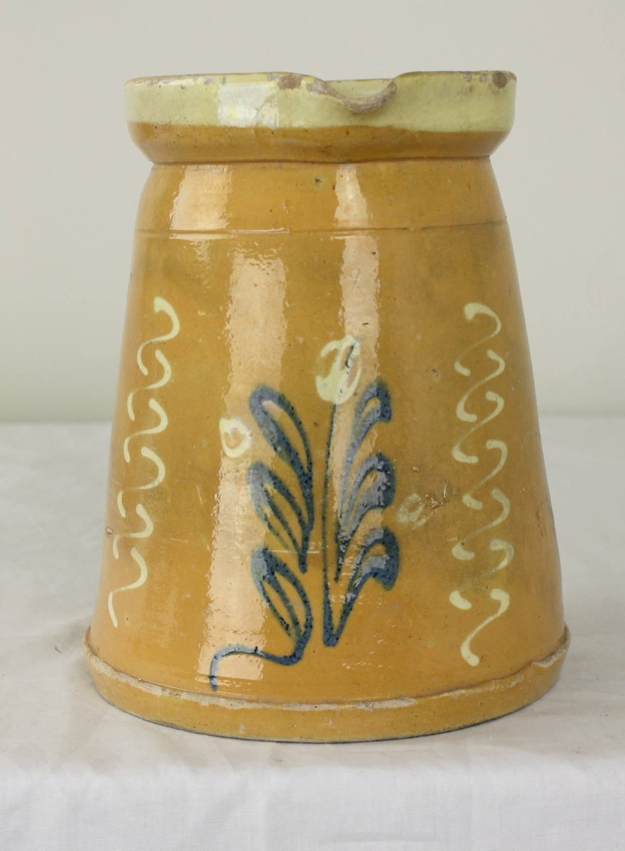 This charming Alsace region pottery jug has a lovely color and colorful flower decoration.  This jug is a large size and is suitable as a decoration or a classic jug or vase.
