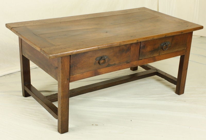 A chunky two drawer cherry coffee table with mitered top and a stretcher base. Wonderful patina and graining on the top, which has been polished to a glow.  Two roomy drawers, 15 1/2