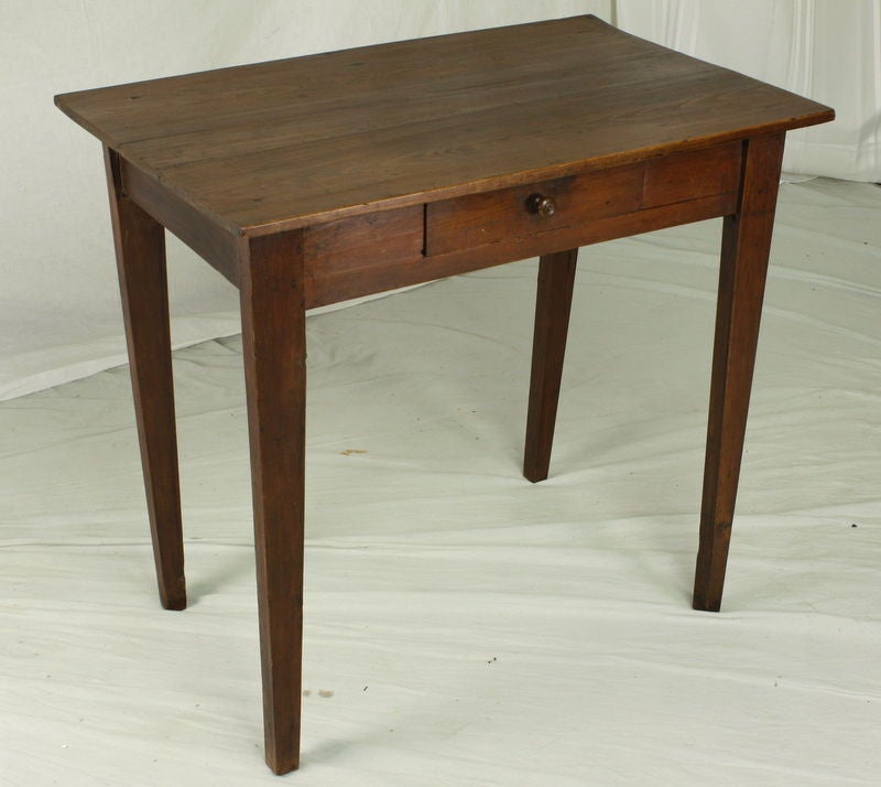A small antique side table from France. Made of pine with a deep rich color. One drawer. Works well as a lamp table.<br />
<br />
See similar examples of antique side tables on our website www.BriggsHouse.com.<br />
<br />
Briggs House, fine