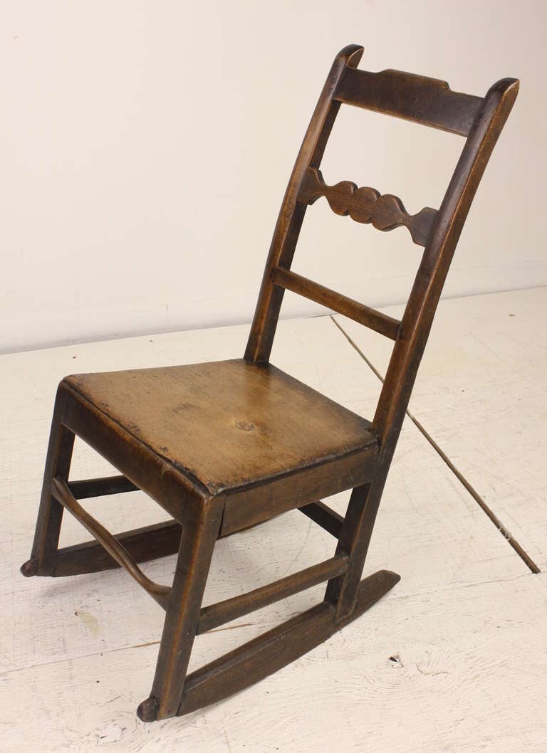 Sweet little rocker, very nice antique look. Very well used, note the wear on the front stretch. The patina and color are very desirable.