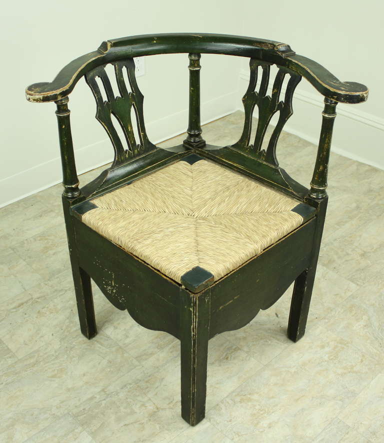 A substantial size, this lovely early corner chair, has very old paint, worn in a most wonderful way, lending great character.  The chair would have been a commode in its earliest form, however it has been converted to a standard chair with the