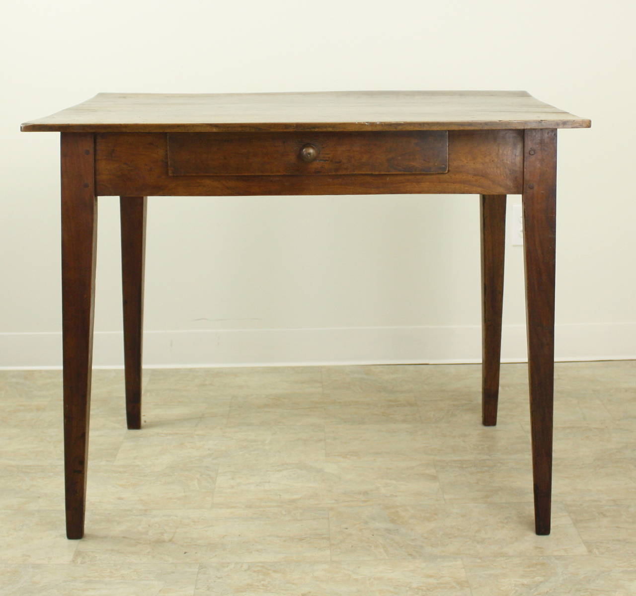 An elegant smaller writing table or desk with tapered legs and a good apron height for knees at 25