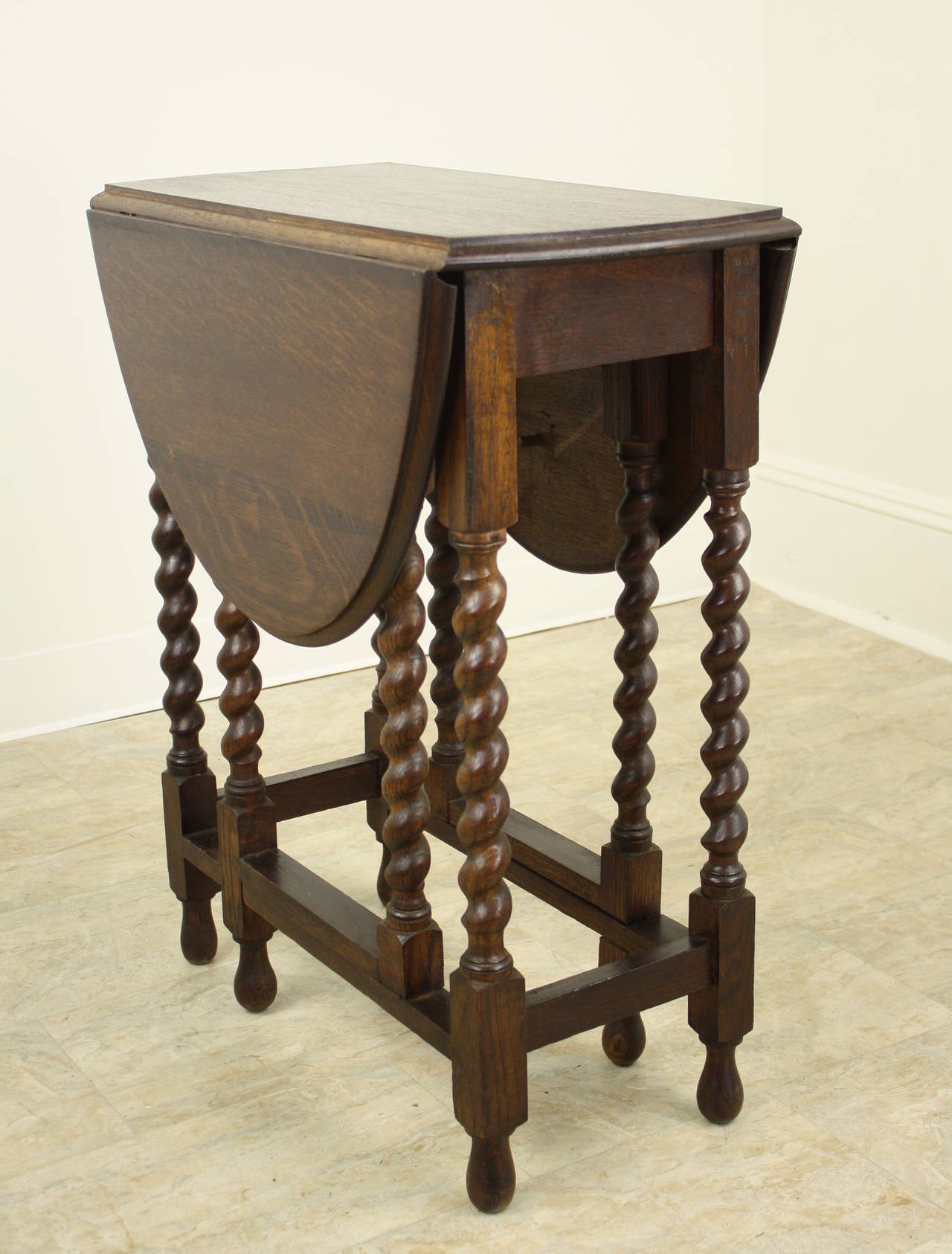 This charming table is a very good size, and height, for an end table or side table.  It is Renaissance reproduction dating 1900, and is a good height for a lamp table.  Nice dark oak with the excellent configuration of a gate leg table,