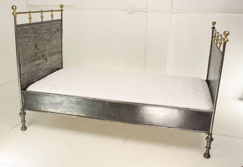 A pair of French steel campaign beds, circa 1890, in rich gray steel with brass accents and medallions.  The feet add a good solid note.  Beds have new custom mattresses for the frames, which tho close to standard twin-bed size, are very slightly