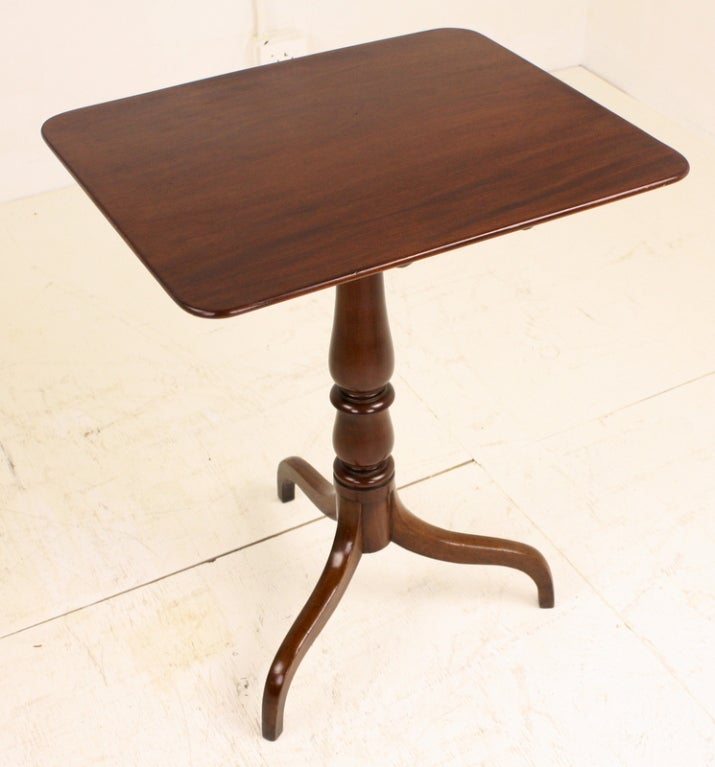 Excellent example of this lovely style of tripod pedestal-base occasional table, period Georgian mahogany. One-board-top is fixed in place. There is a beautifully turned and shaped pedestal. Fully restored, with a very nice color, grain and patina.