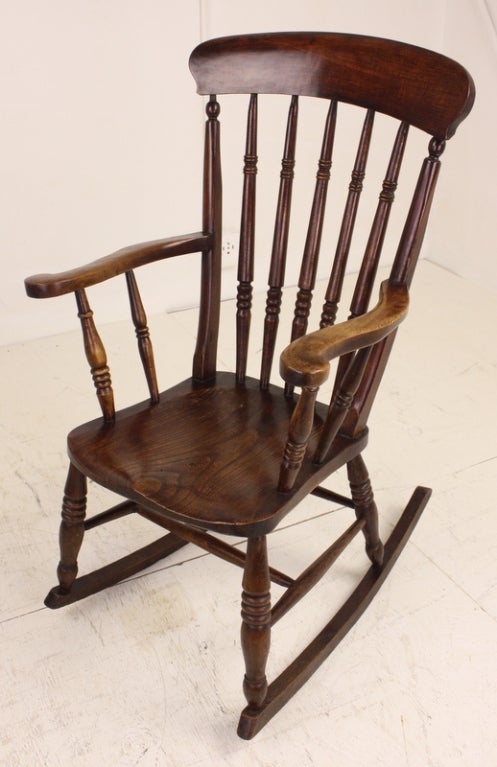Classic English oak country rocking chair, very comfortable, and very sturdy.  Lovely hand turnings on spindles and legs.  Very gracefully shaped arms.