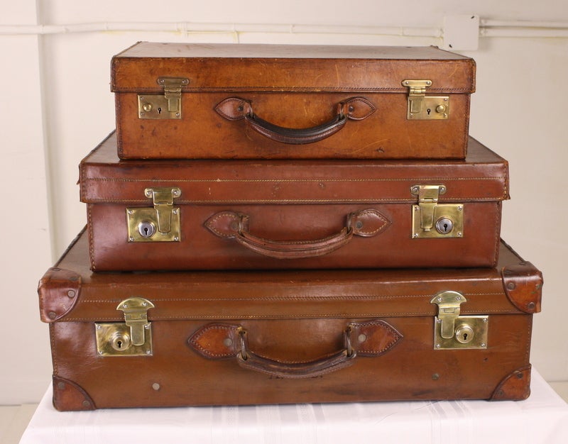 Beautifully burnished leather, stack of three very smart vintage suitcases.  These look great on top of a bookcase or a cupboard, lending a little charm and interest.  Good and clean inside.  Good brass latches.  Measurement below is for the largest