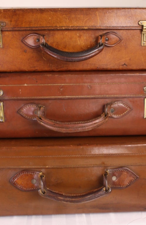 Stack Of Three English Leather Suitcases 1