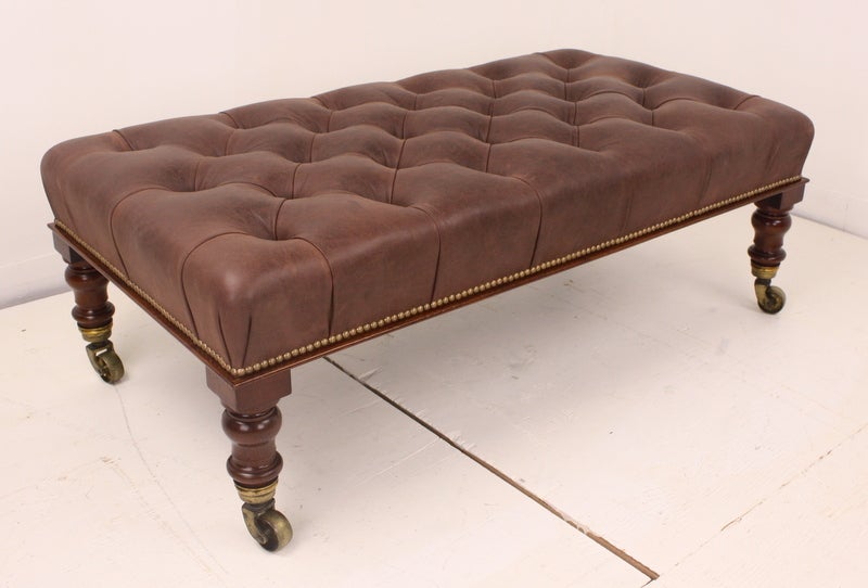 Large size, this is a good coffee table, useful with a tray on top.  New distressed leather, lovely antique legs and original castors.  Sturdy for seating.