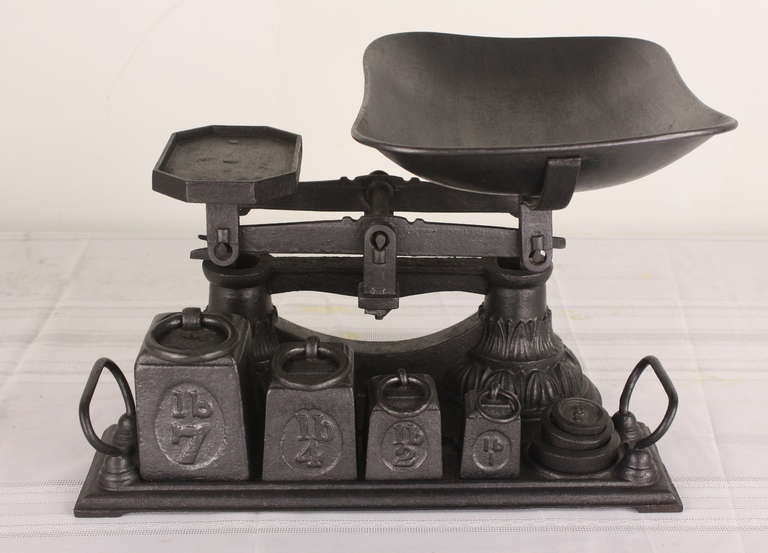 Very heavy! A dramatic look, we would probably fill it up with caramels or something to snack on at a party. There are four square weights and three smaller round weights. Weights range up to 7 pounds for the largest! A Classic Victorian scale.