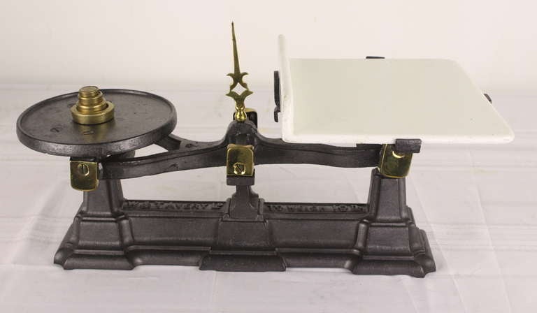 This English Victorian scale would have been used for food, which is why the porcelain tray is perfect. Nice decorative elements on the scale. Included is a set of brass weights for the grocer to weigh the cheese! Great for the counter. Avery scales