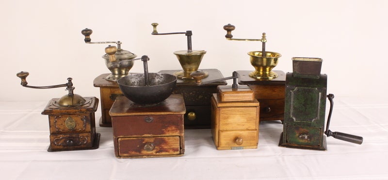A very charming assortment of French coffee grinders, for a kitchen shelf or counter.  Some with brass, some with iron, one is tin, one is tin and made by Peugeot(see final thumbnail, green grinder).  Fun.  Heights range from 7-11