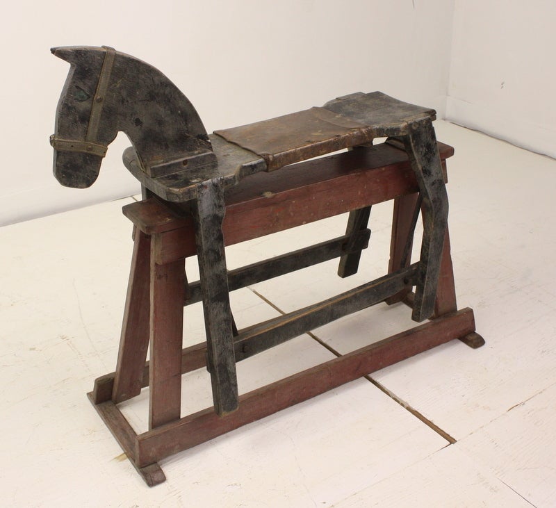 Charming face and wonderful worn color, this rocking horse will sit happily anywhere you choose to place it. The worn leather seat has seen lots of rocking children.