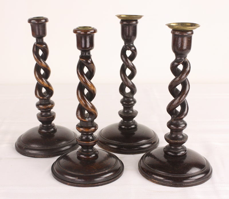 Hand carved open barley twist candlesticks, England c 1890.  Eye catching and handsome.  Measurements below are for the pair with the brass saucer tops.  The other pair measure 10 3/4 high and 5 1/4 in diameter. These often call for slight shaping